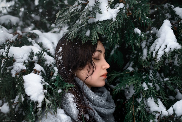 Woman in snow surrounded by trees