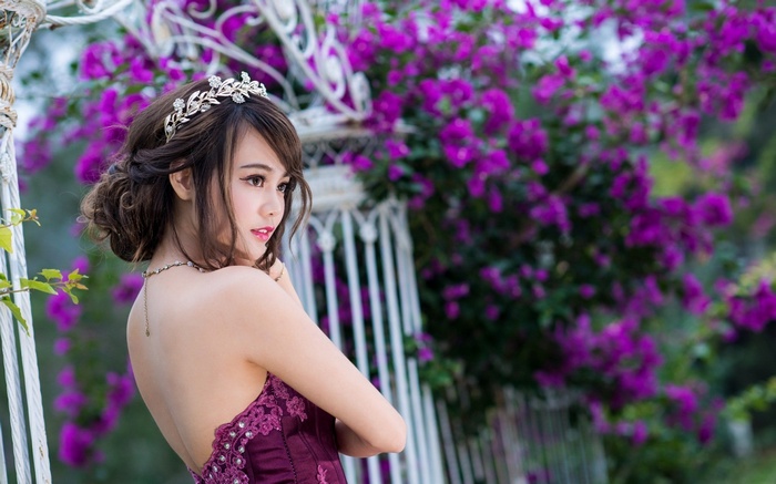 Asian woman in a purple dress with a tiara
