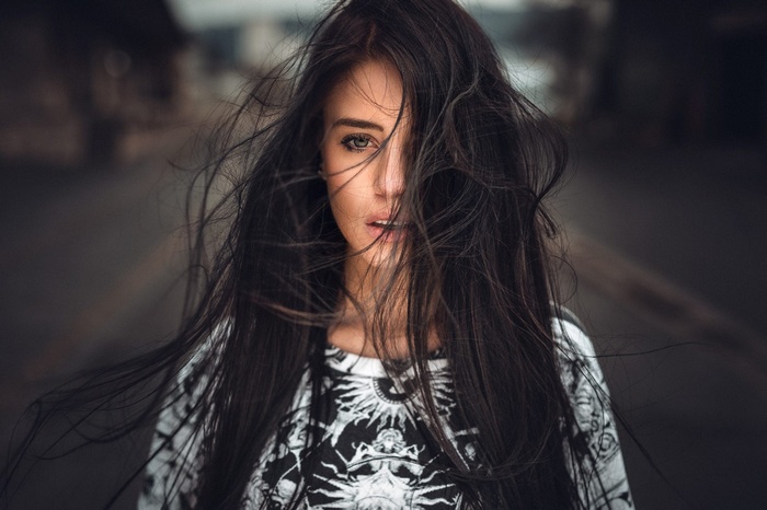 Woman with dark hair blowing in the wind