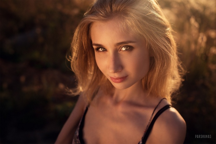 Woman with blonde hair looking at viewer