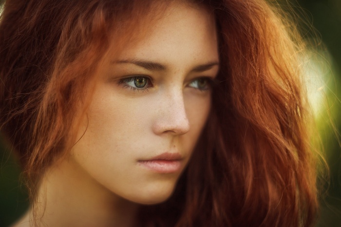 Woman with red hair and green eyes