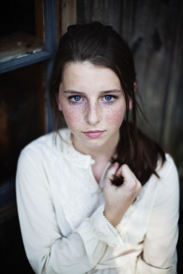 Young woman with blue eyes and freckles