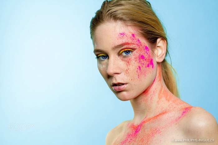 Woman with colorful body paint and blue eyes
