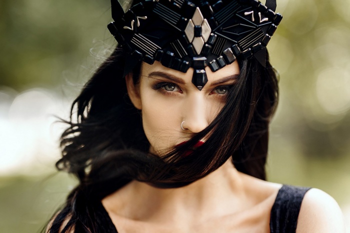 Woman with black hair and crown