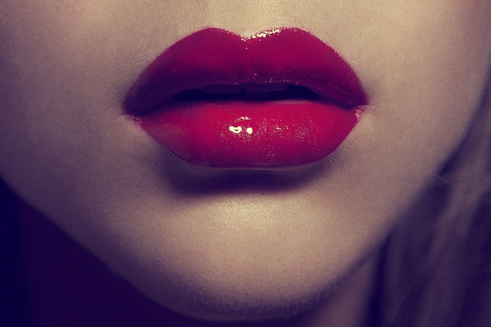 Close-up of glossy red lips