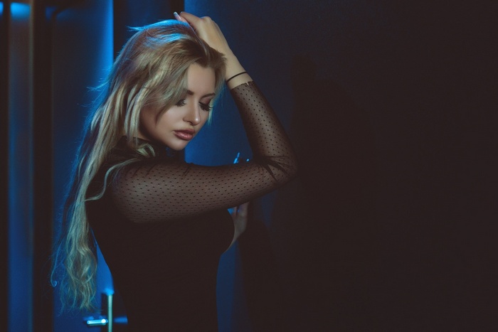Woman with blonde hair in black top
