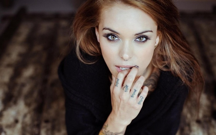 Woman with tattoos and auburn hair