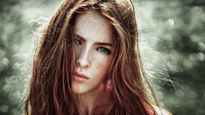 Close-up of a young redhead woman with freckles