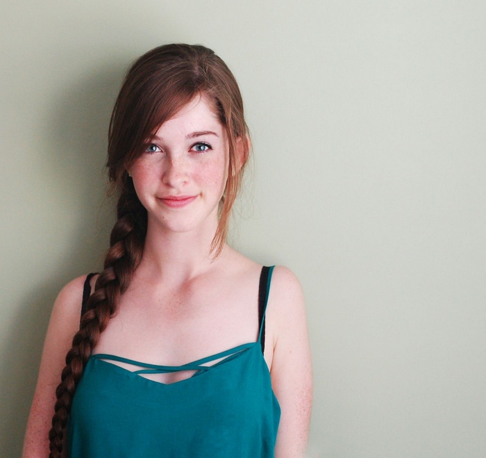 Young woman with red hair and freckles