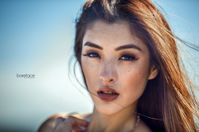 Woman with freckles and makeup, outdoor portrait