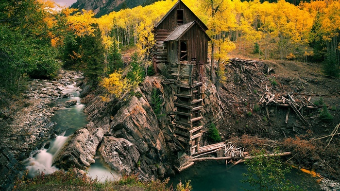 Abandoned Mill on Rocky Cliffside in Autumn