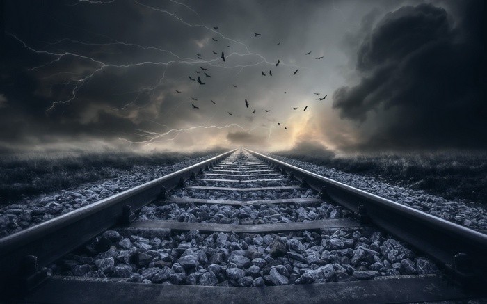 Railway tracks under a stormy sky with lightning and birds