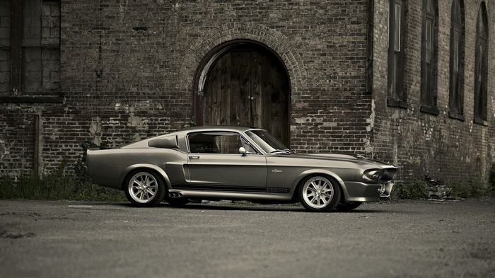 1967 Ford Shelby GT500 Mustang parked by brick building