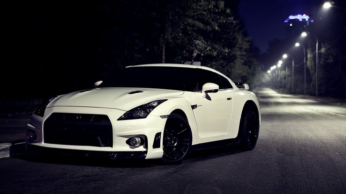 White Nissan GT-R R35 parked on a street at night