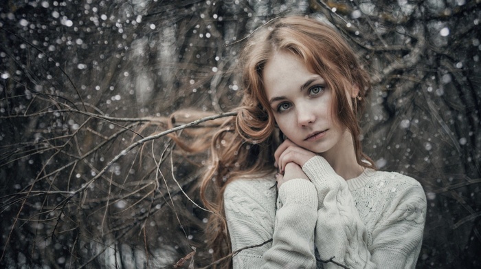 Woman in a white sweater in the snow