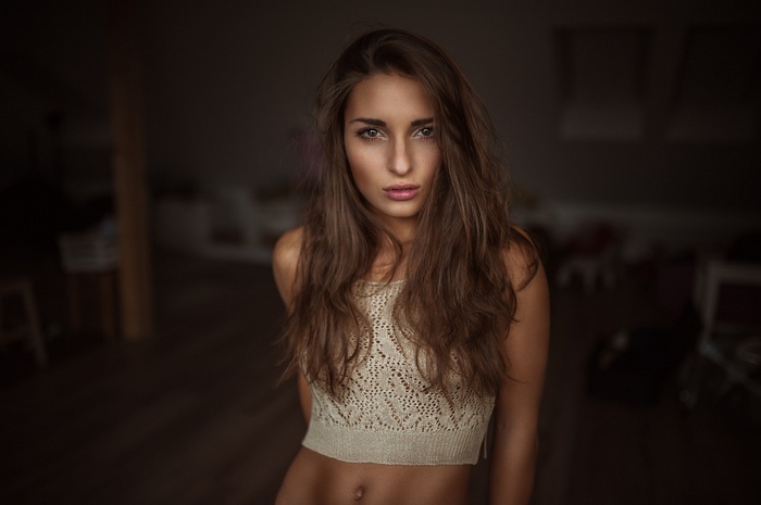 Woman with long brown hair wearing a crop top