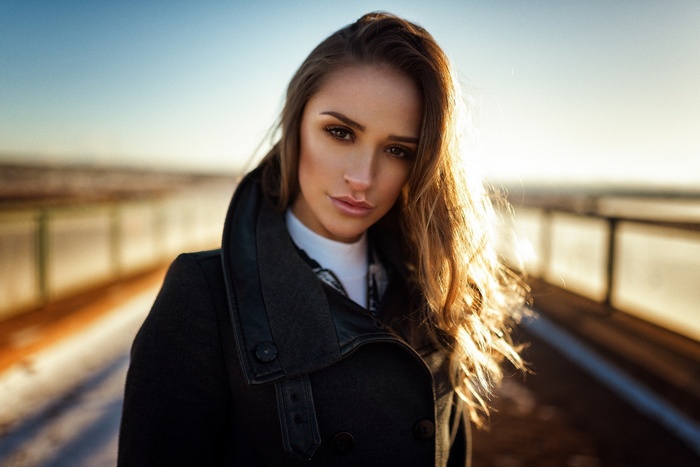Woman in black coat with sunlight