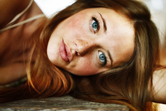 Woman with freckles and blue eyes