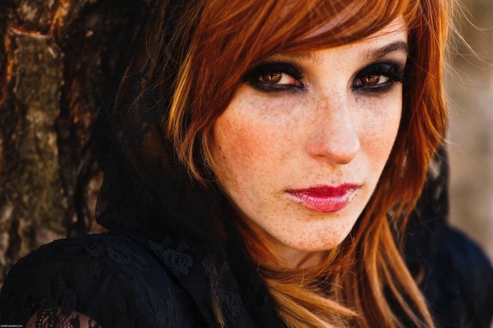 Woman with freckles and red hair wearing black lace