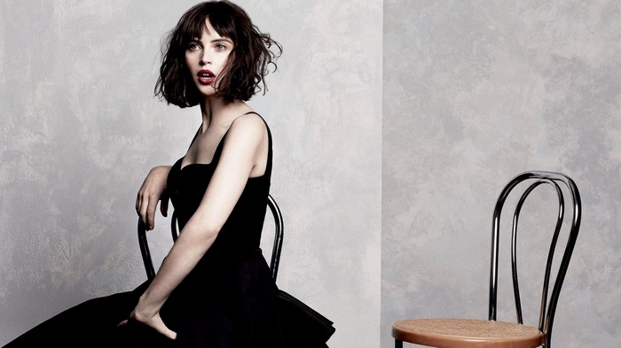 Felicity Jones sitting on a chair