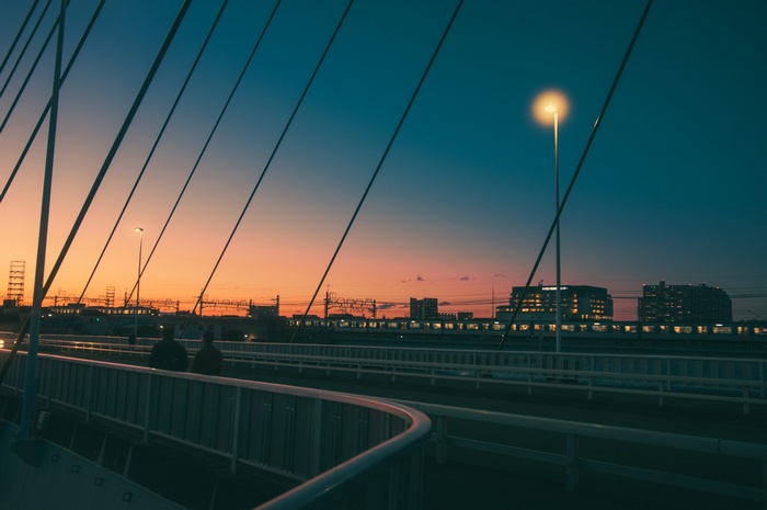 Cityscape at sunset with bridge and train