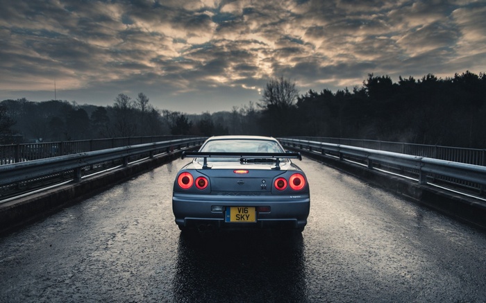 Nissan Skyline GT-R R34 on a wet road