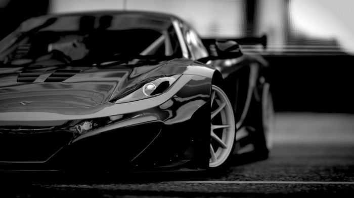 Black McLaren M26 race car front view