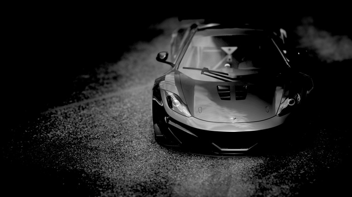 McLaren MP4-12C sports car on gravel road