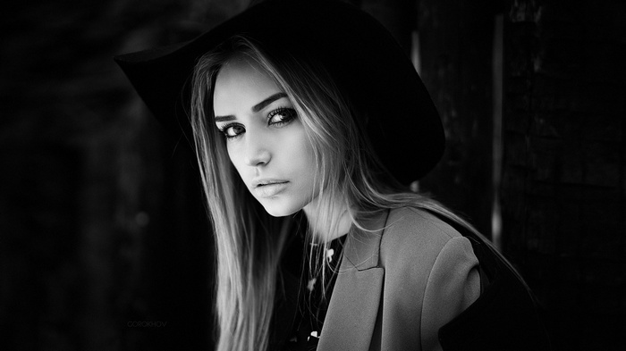 Woman wearing a hat and coat, monochrome portrait