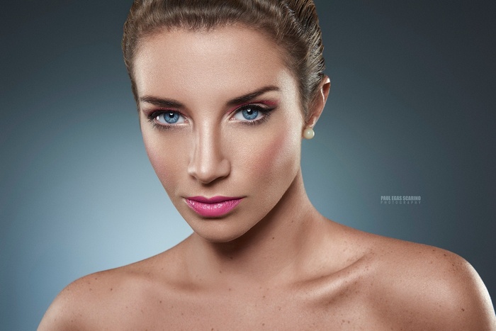 Woman with blue eyes and pink lipstick