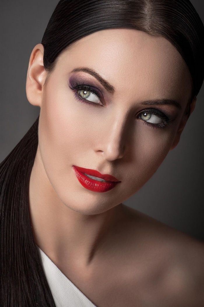 Woman with red lipstick and purple eyeshadow