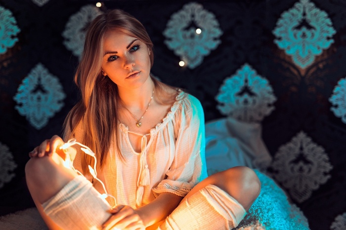 Woman sitting with fairy lights