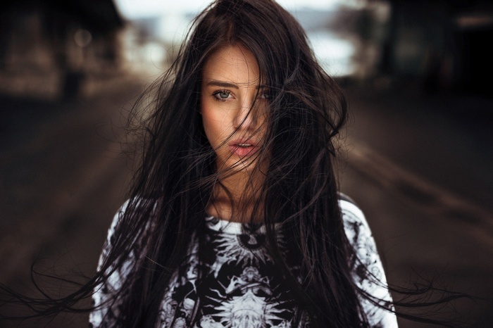 Woman with dark hair blowing in the wind