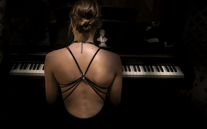 Woman in black dress at a piano