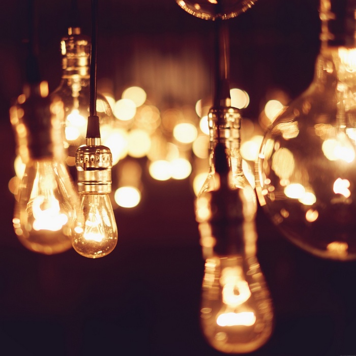 Close-up of glowing Edison light bulbs with bokeh
