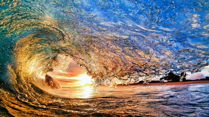Wave crashing at sunset