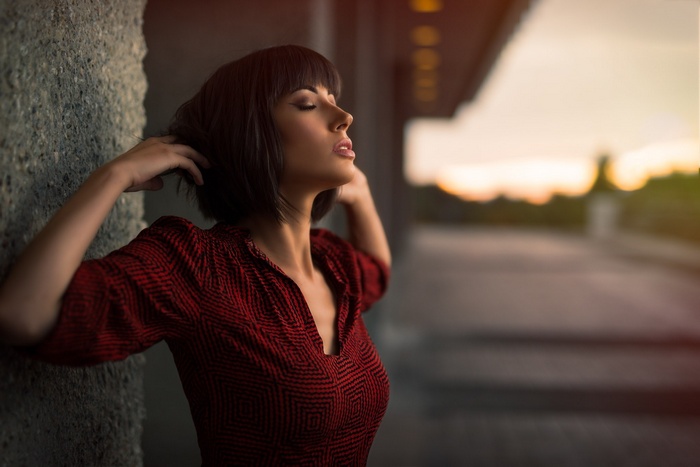 Woman with short hair and red dress outdoors