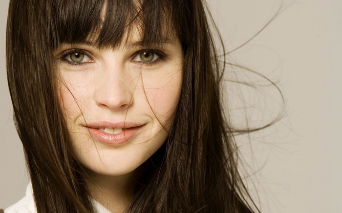 Felicity Jones smiling with long brown hair