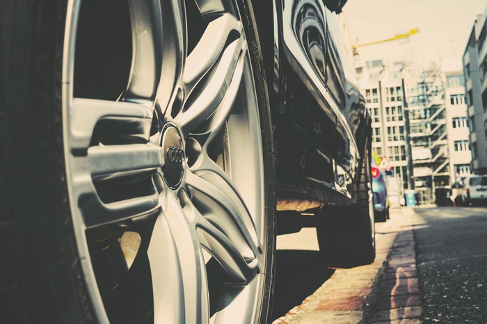 Audi car wheel parked on city street