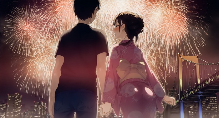 Couple watching fireworks in a city