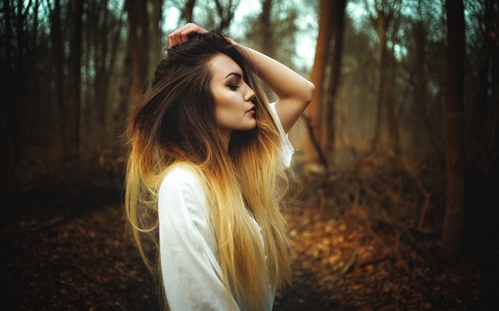 Woman with long ombre hair in a forest