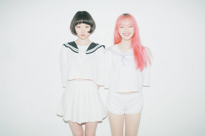 Two Asian women in sailor-style outfits