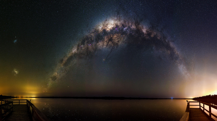 Milky Way over a lake with wooden piers