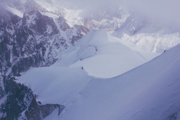 Snowy mountain range with a lone skier