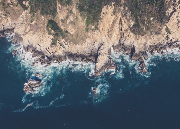 Aerial view of rocky coastline and ocean waves