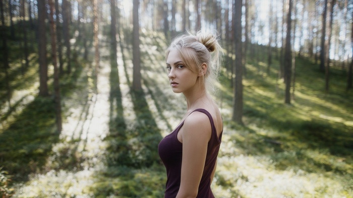Woman with blonde hair in a forest