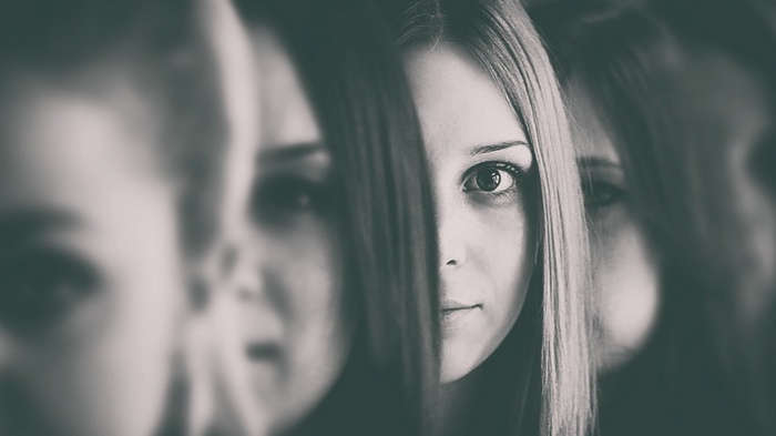 Monochrome portrait of a woman with multiple reflections