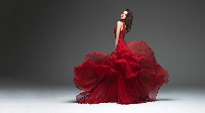 Woman in flowing red dress by Peter Coulson