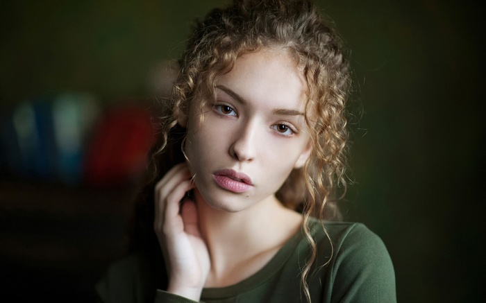 Portrait of a young woman with curly hair