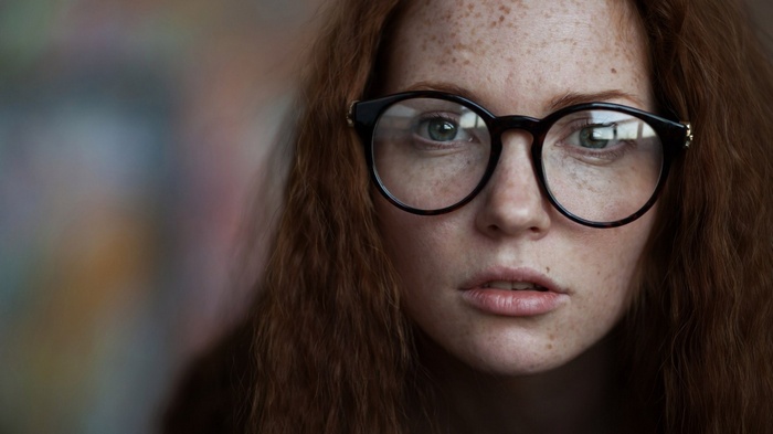 Woman with freckles and glasses